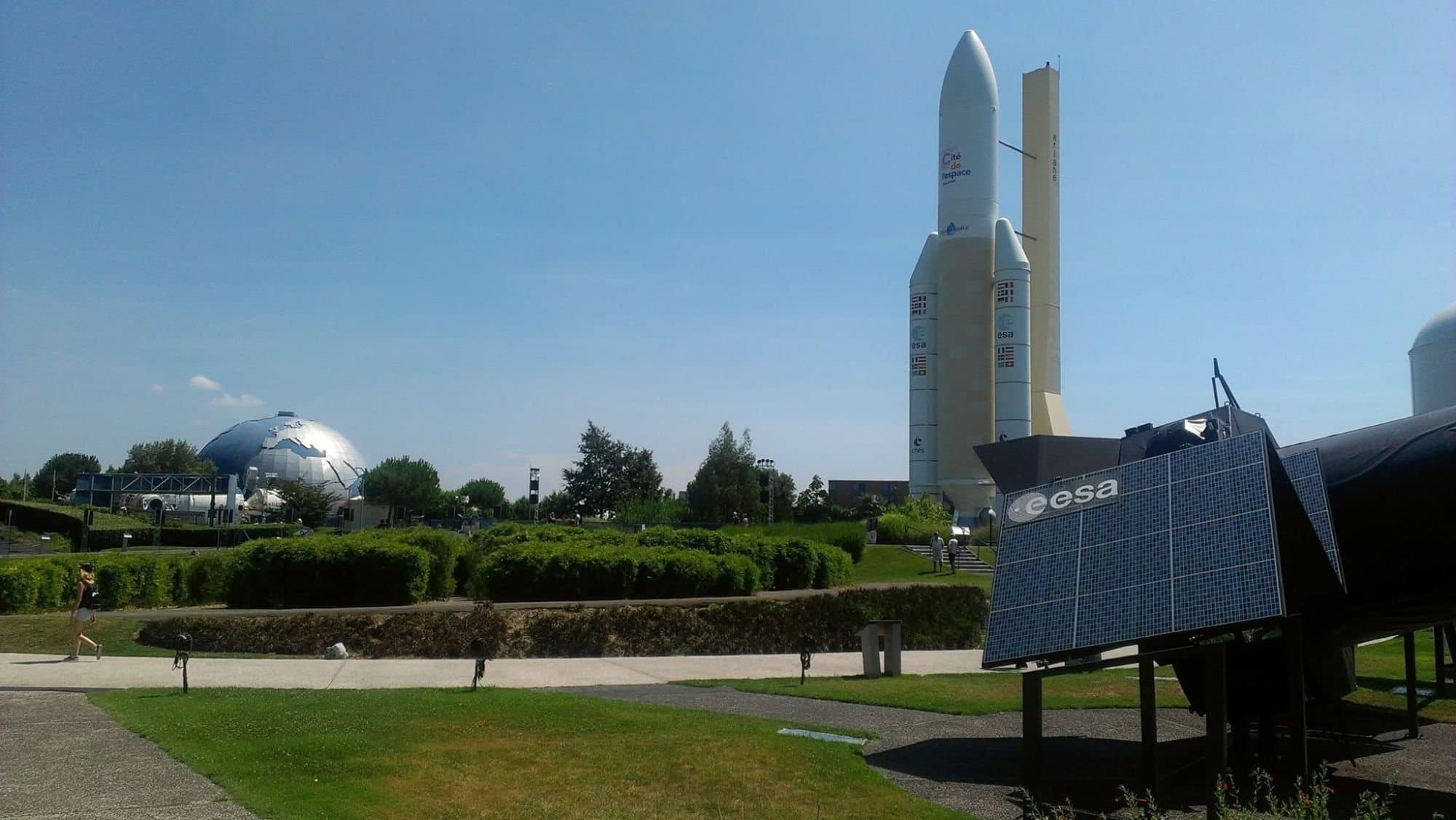 A park with an Ariane 5 replica, a globe-shaped dome and a solar-panelled spacecraft model